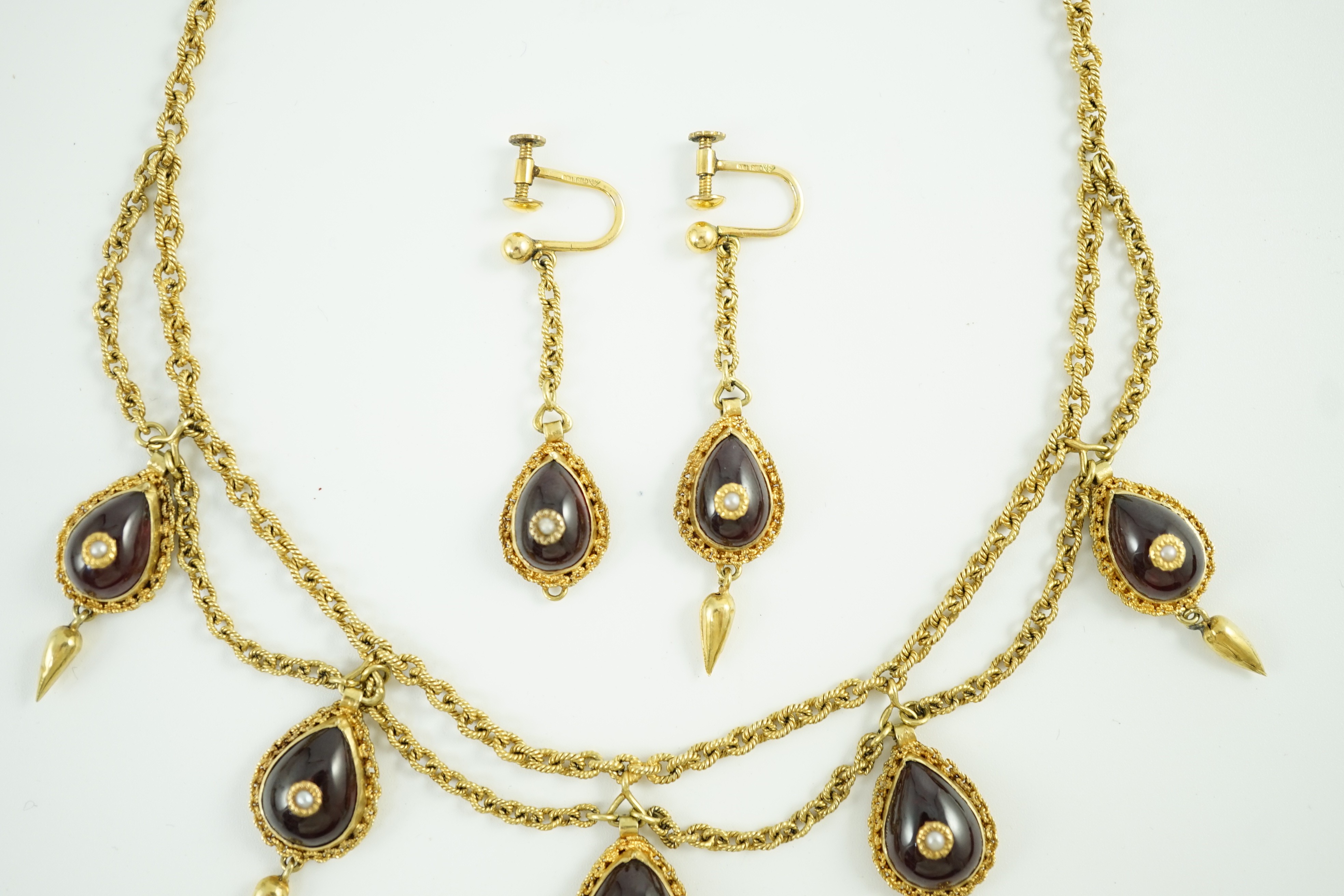 A 19th century Indian gold, garnet and seed pearl set demi parure, comprising and a drop fringe necklace and pair of matching ear clips